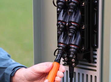 Technician connecting a Multiport Service Terminal Port to a Fiber Drop Cable Assembly