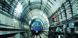 Cable cleats inside a railroad tunnel with a train