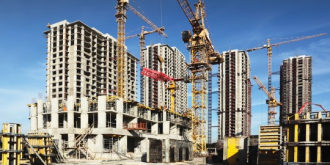 A bustling construction site with laborers and machinery involved in the ongoing building project