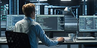 A system administration and machine learning engineer programming at his workstation. 