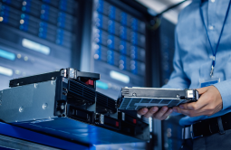 ALT Text: Data Center operator working on installing a new Fiber cassette